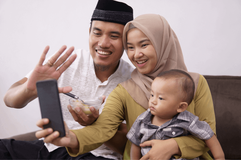 Positive Relationship Asian Muslim Family with Child Video Calling 