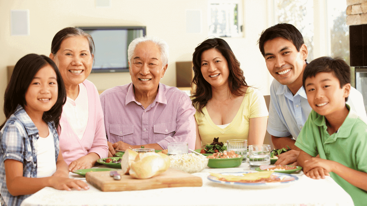 Chinese asian family sitting at table smiling