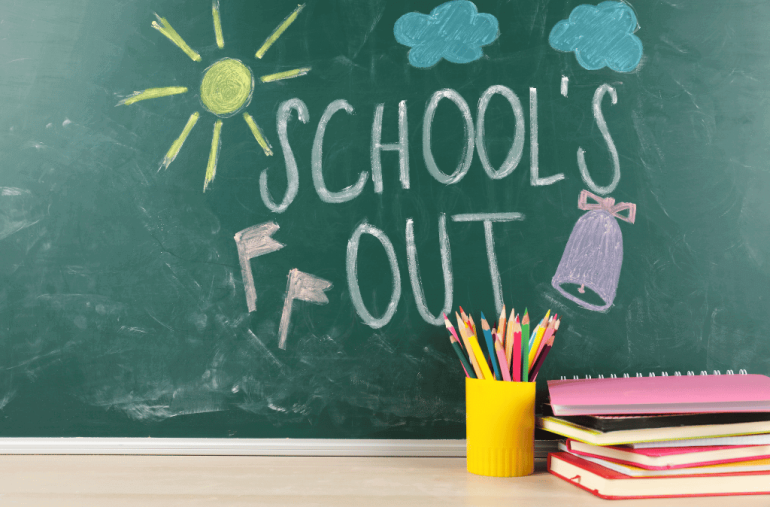 Picture of a blackboard with school's out! written on it. There is a sun and several clouds drawn as well.