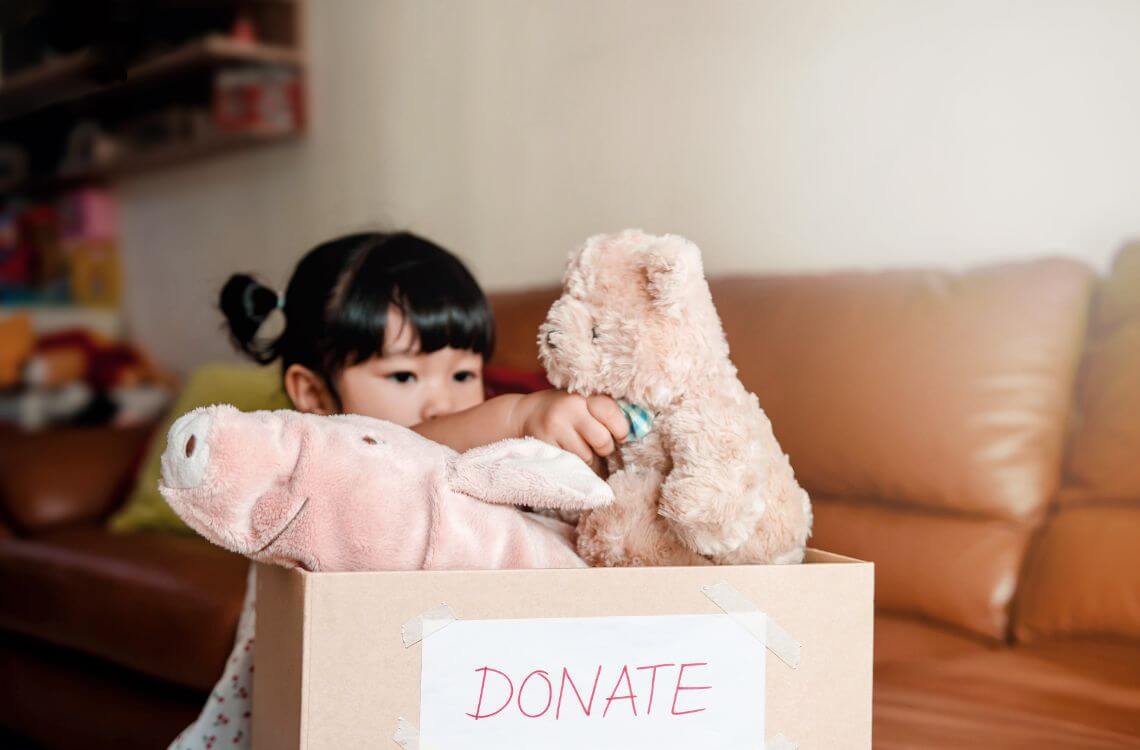 girl donating teddy