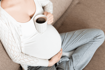 pregnant mum holding coffee