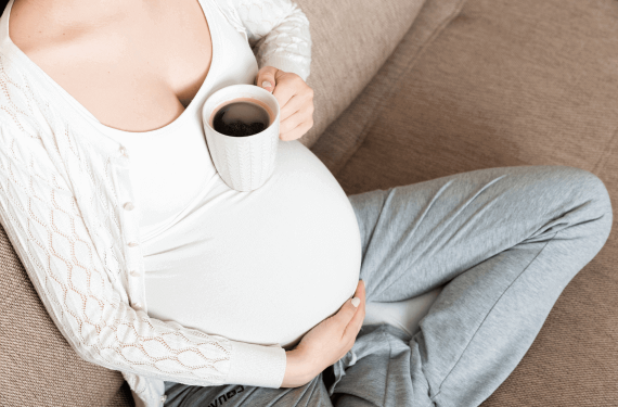 pregnant mum holding coffee