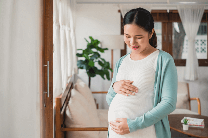 pregnant mum looking at tummy happily