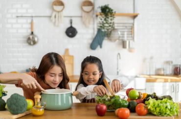 Mother and daughter enjoying making meals