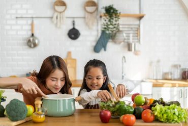 Mother and daughter enjoying making meals