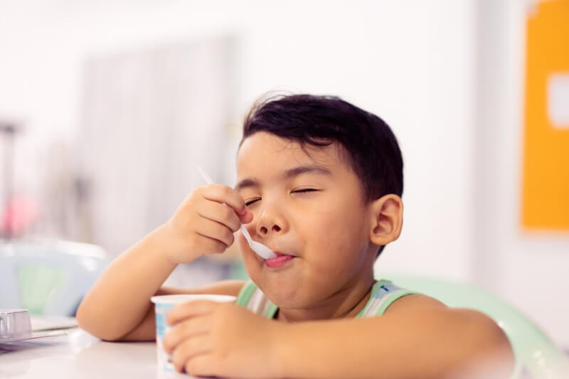 little boy eating yoghurt