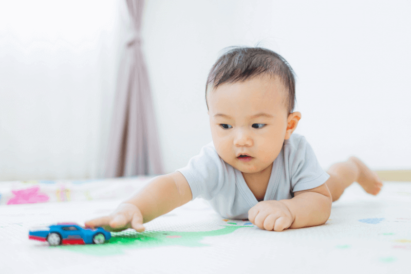 baby reaching for toys