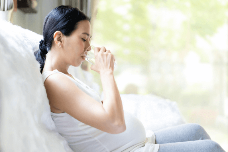 pregnant woman drinking water