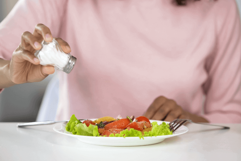 adding salt to food