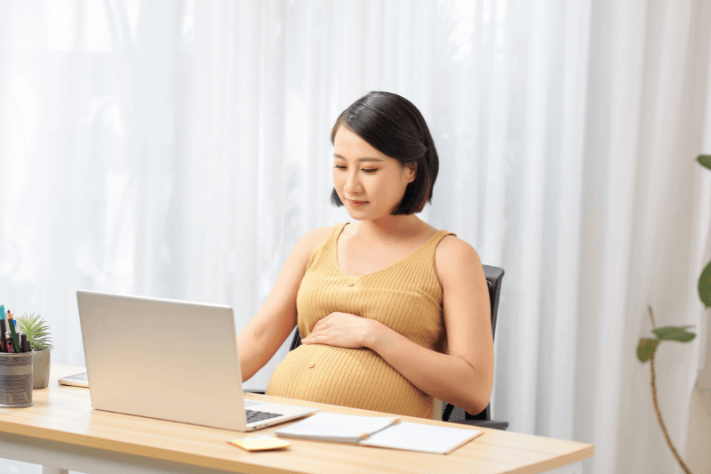 pregnant mum sitting doing work