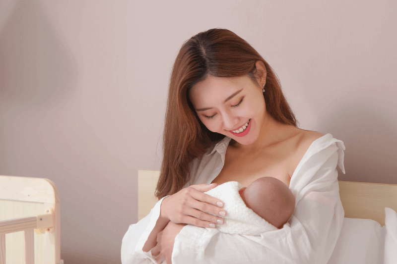 happy mum breastfeeding baby