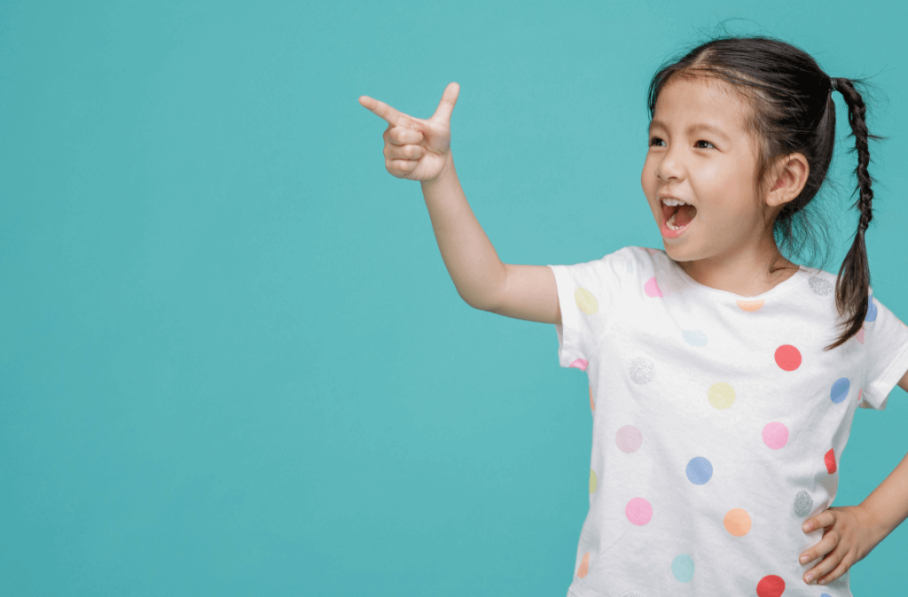 A girl pointing happily