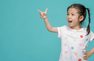 A girl pointing happily