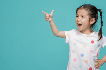 A girl pointing happily