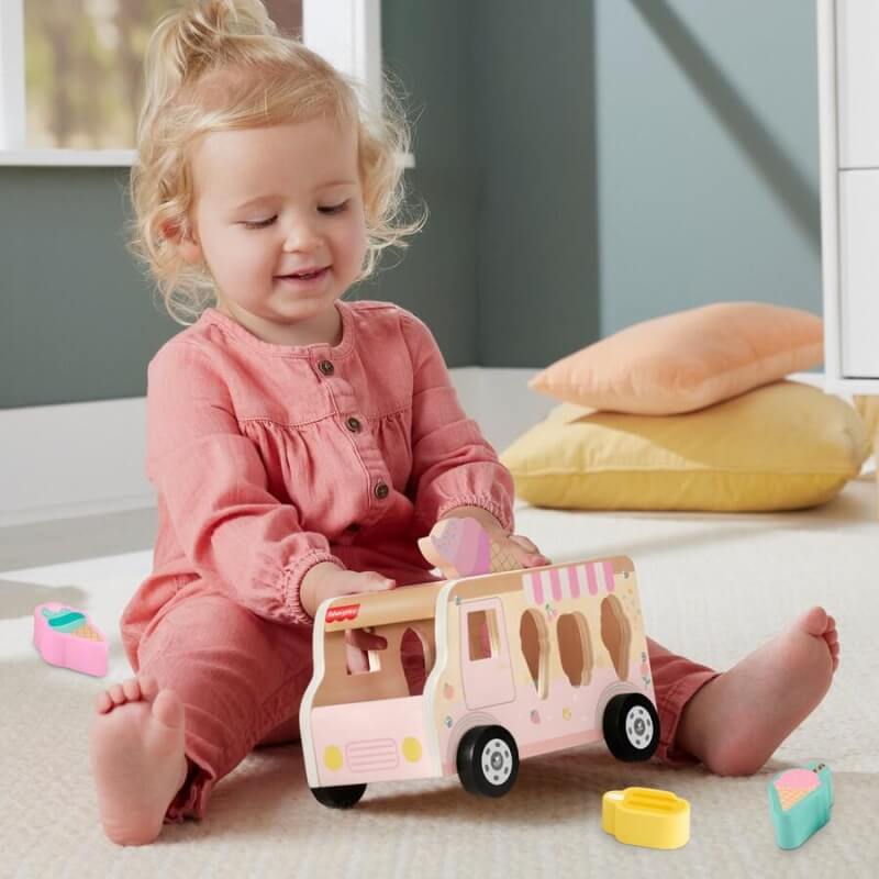 Female toddler playing fisher price ice cream wooden toy