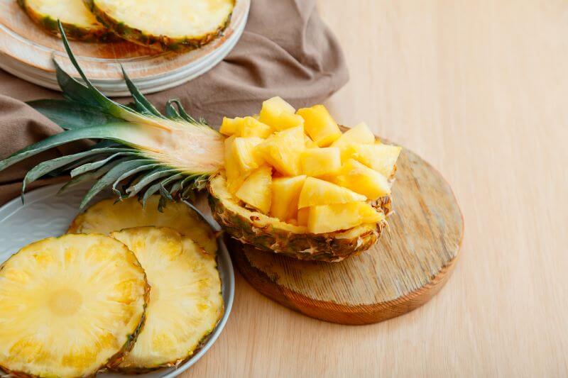 sliced pineapple in pineapple bowl