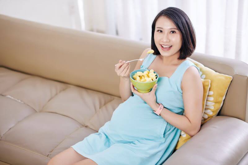 pregnant woman enjoy eating pineapple