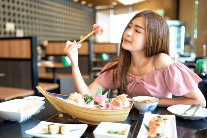 woman looking at sushi