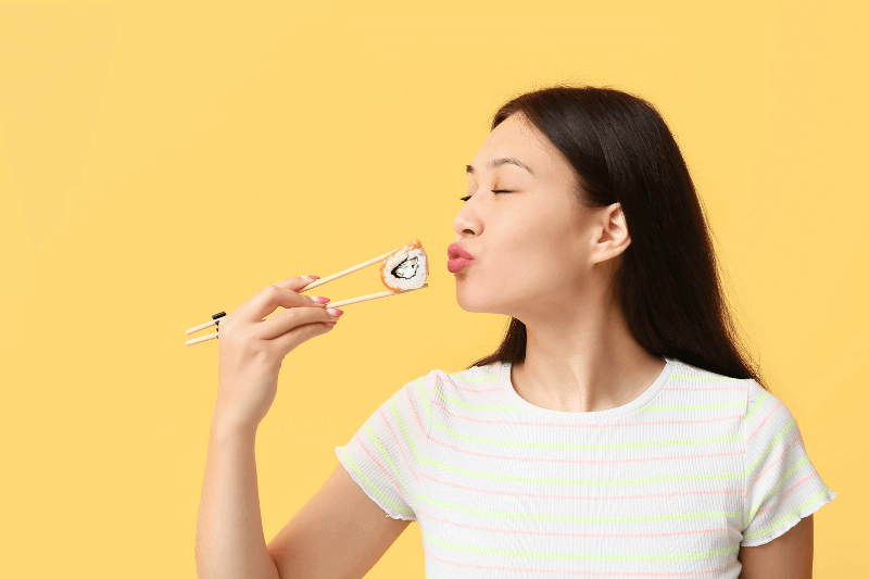 woman enjoying sushi