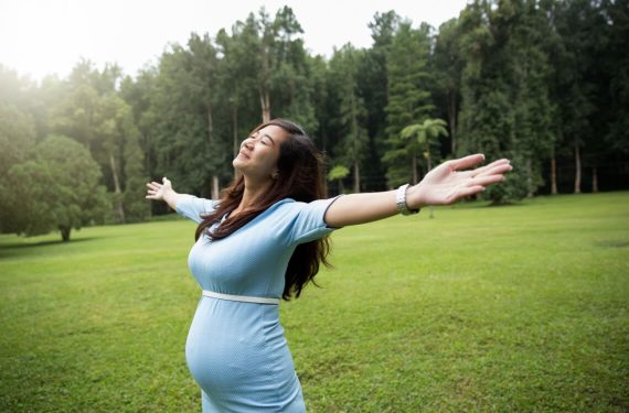 pregnant mummy embracing nature