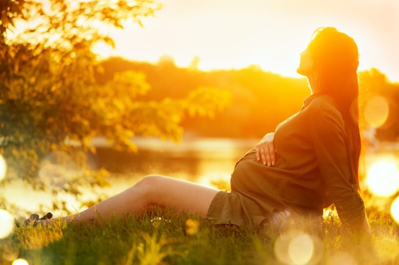 pregnant woman enjoying sunset