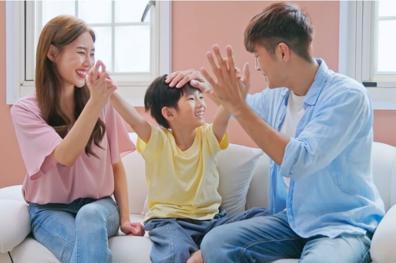 parents encouraging young child