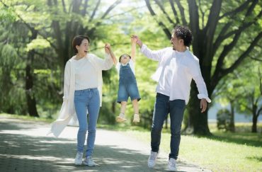 parents walking with child in park