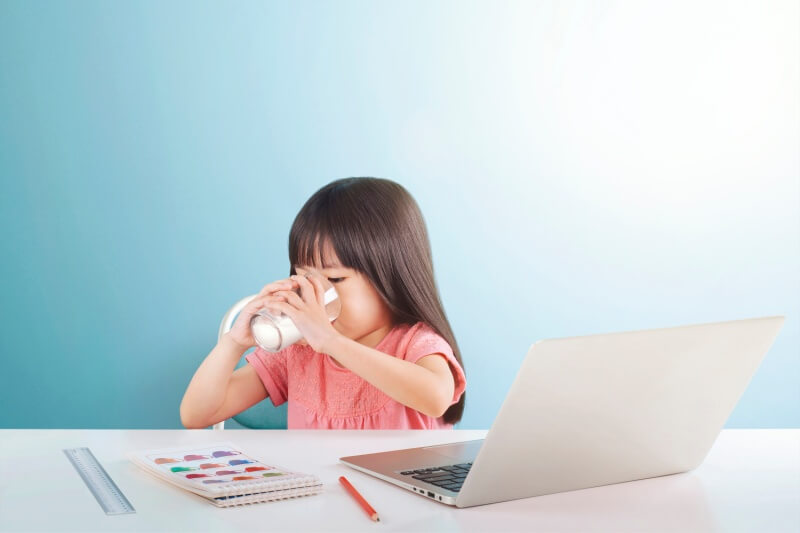 young girl enjoying milk for brain development