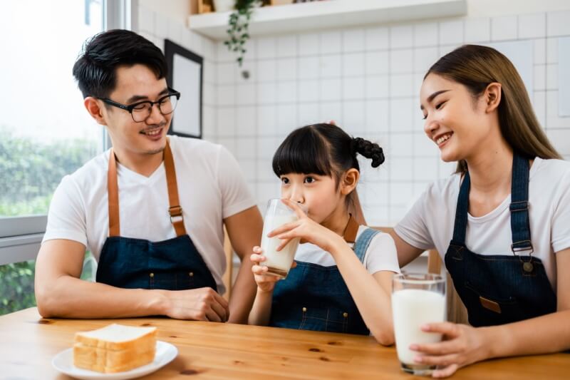 happy family enjoying glass of milk together