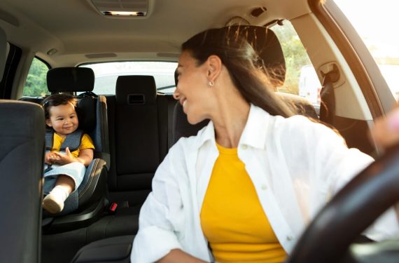 mummy looking at daughter in car seat