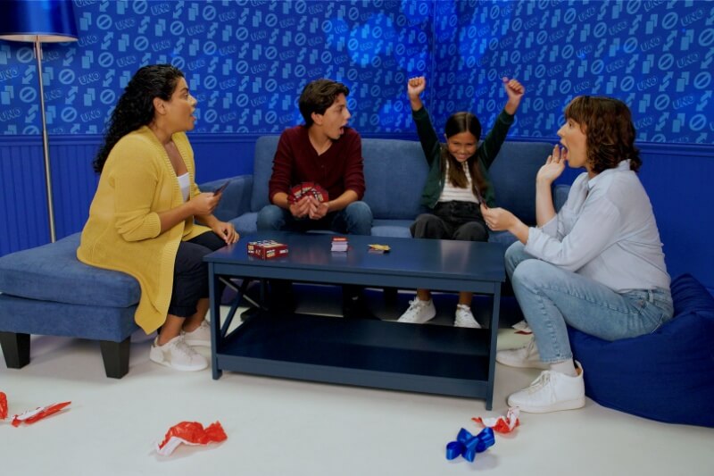 families enjoying holiday season playing uno cards