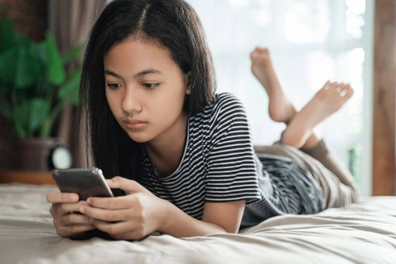 young girl using handphone