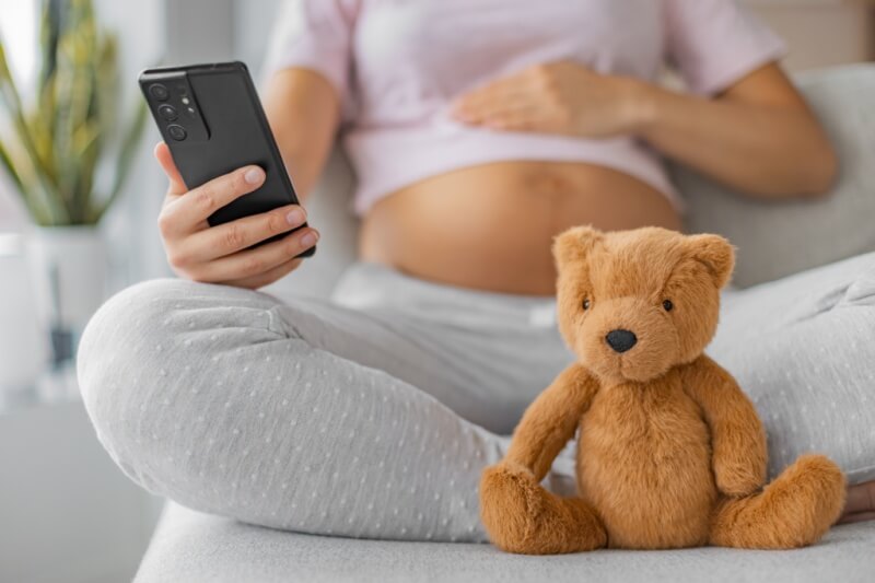 pregnant woman using phone