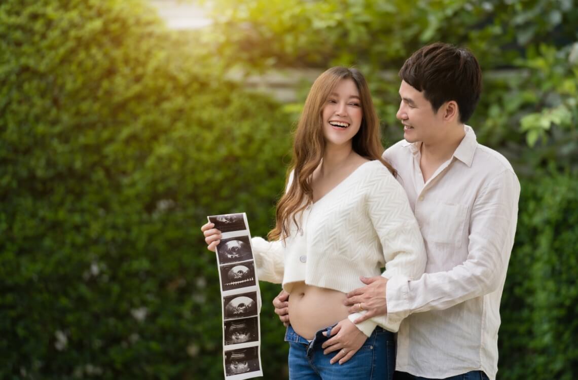 couple holding pregnancy ultrasound