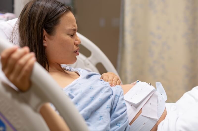 woman sitting on hospital bed for labour