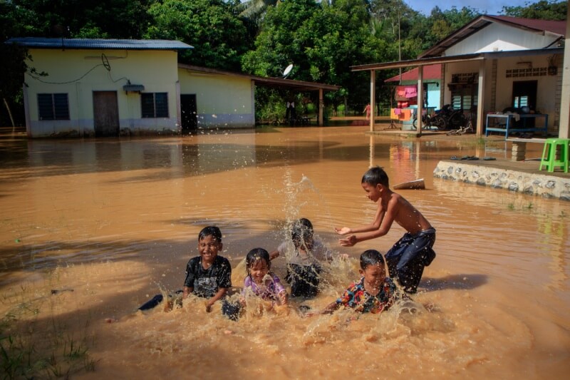 children playing in flood water