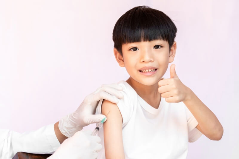 young boy taking vaccine