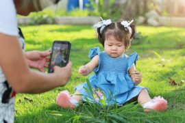 parent taking picture of child