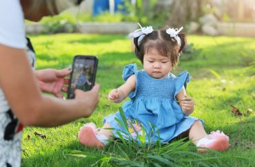 parent taking picture of child