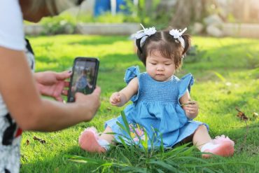 parent taking picture of child