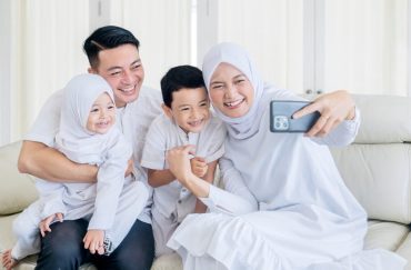 family taking selfie together