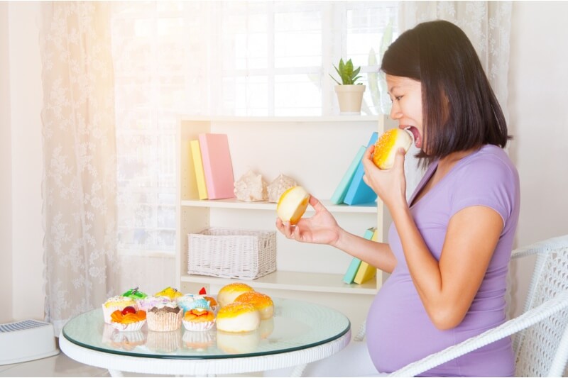 pregnant woman eating desserts