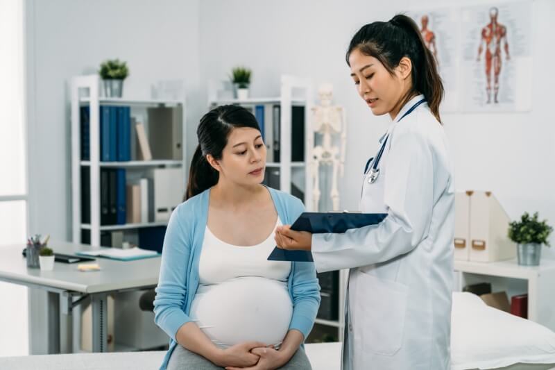 pregnant woman with doctor in clinic