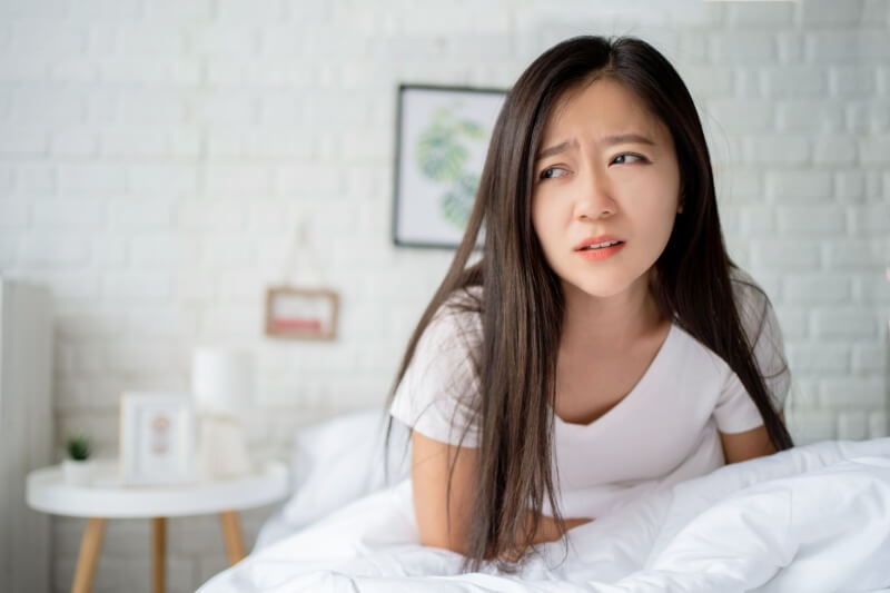 woman feeling sick and queasy