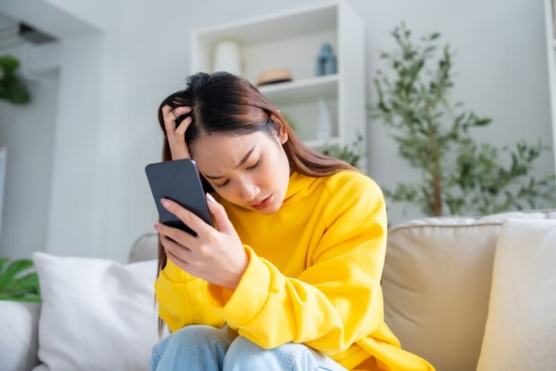 woman in yellow sweater thinking