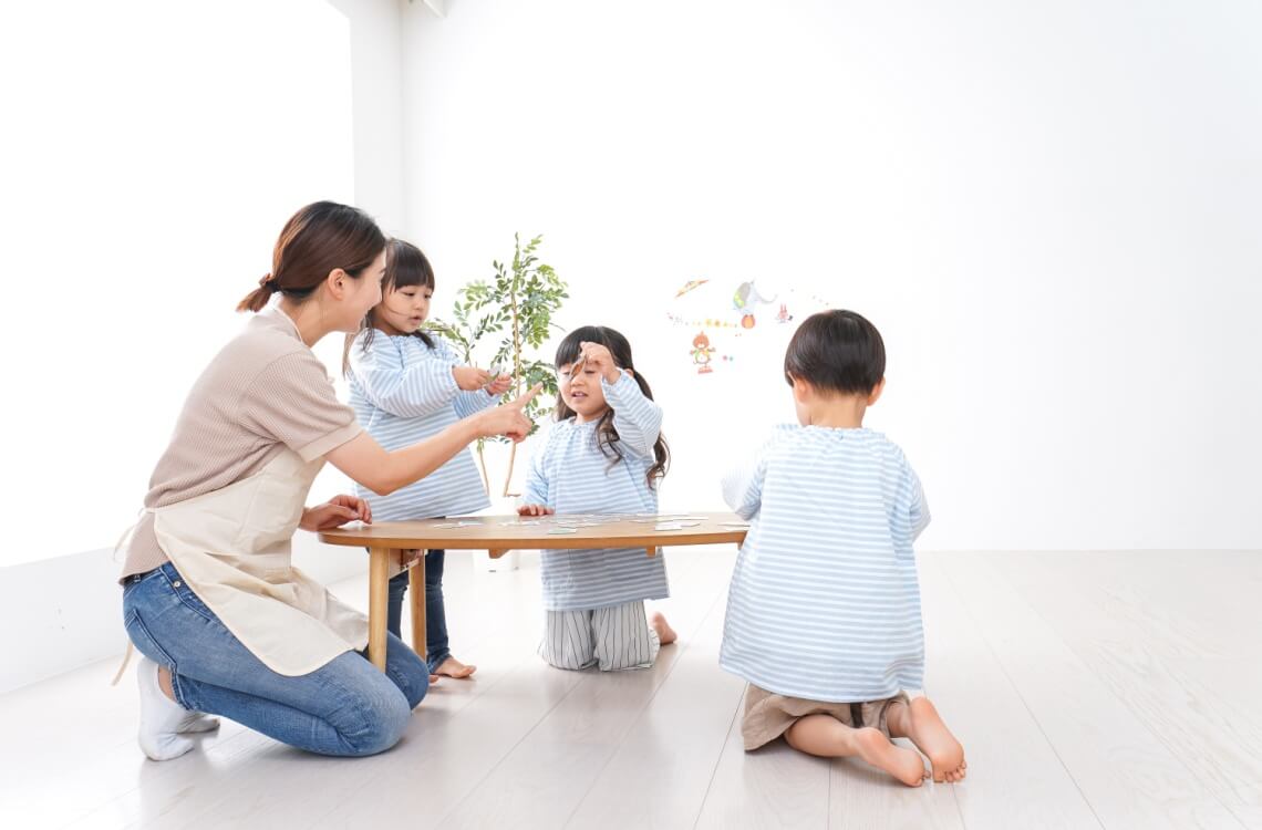 caretaker playing with children toddlers