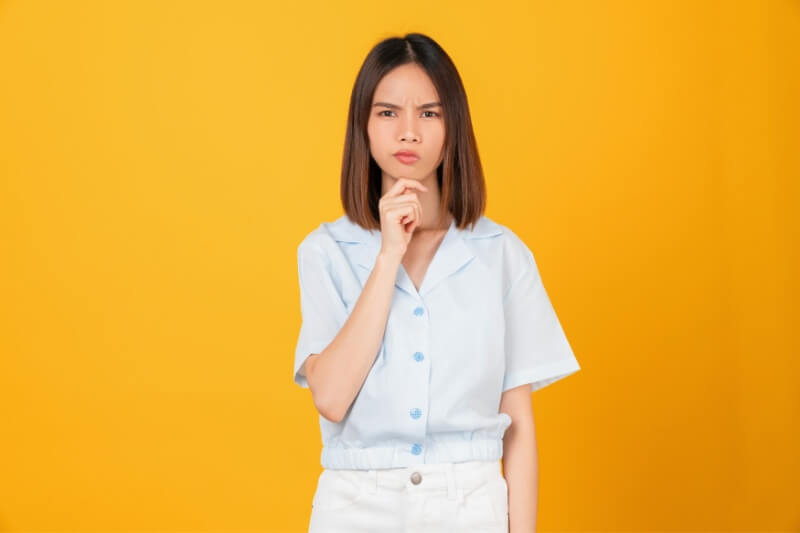  young woman shrugging shoulders