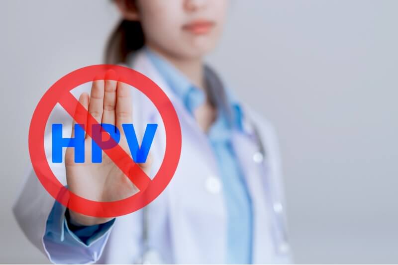  female doctor showing stop virus symbol