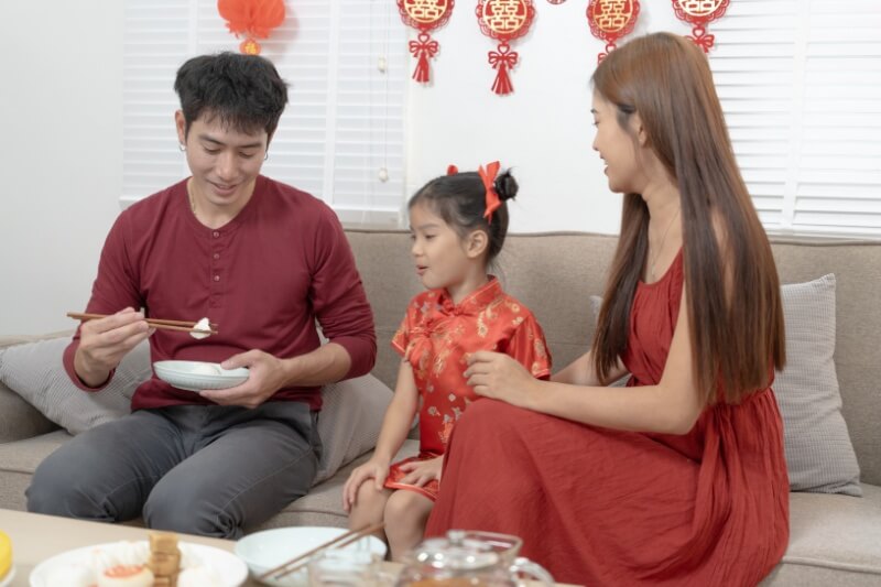 Asian family preparation red lanterns in their house and celebrating chinese new year