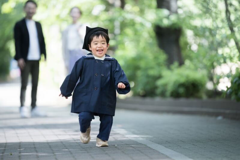 child in uniform running with a smile on their face